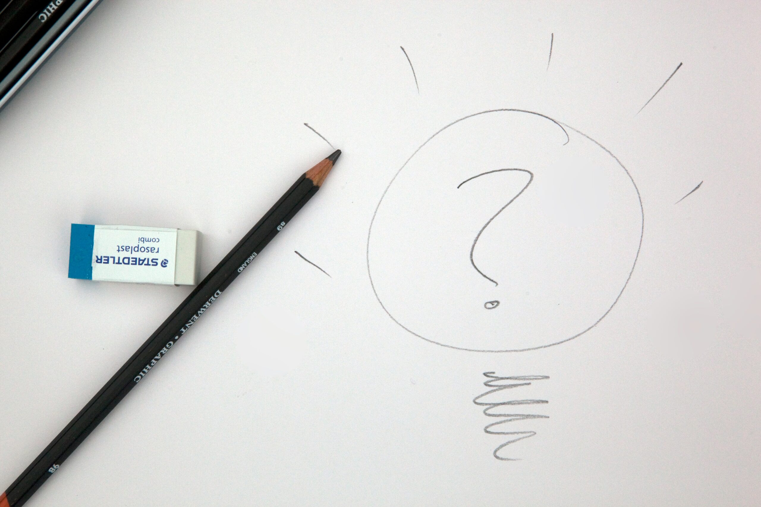 An image depicting a pencil drawing a large question mark on a piece of paper, symbolizing a question or dilemma faced by a Product Management professional.